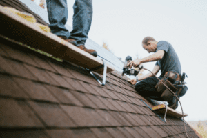 A logo of wells roofing and remodeling